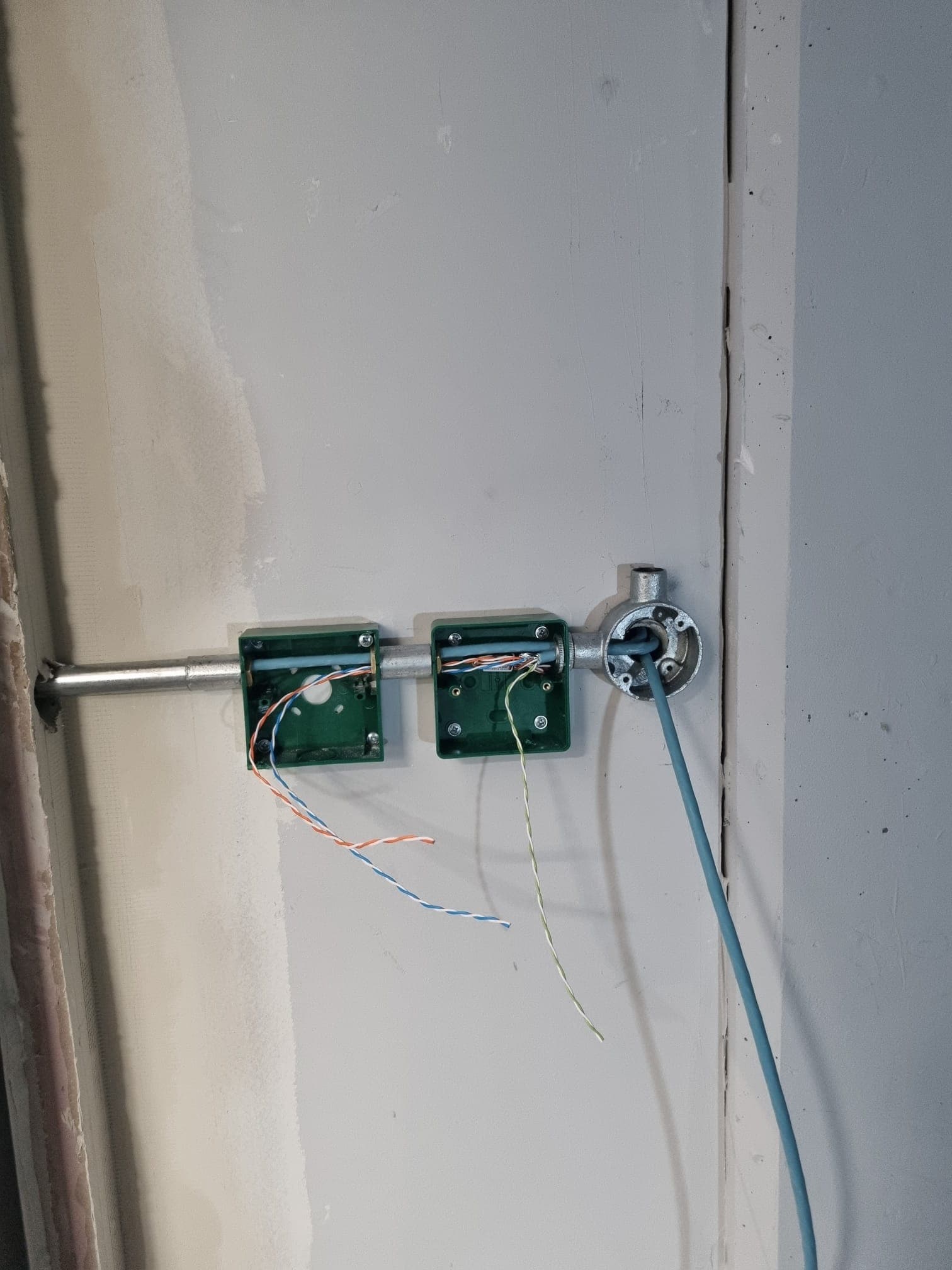Conduit and data cabling through green junction boxes